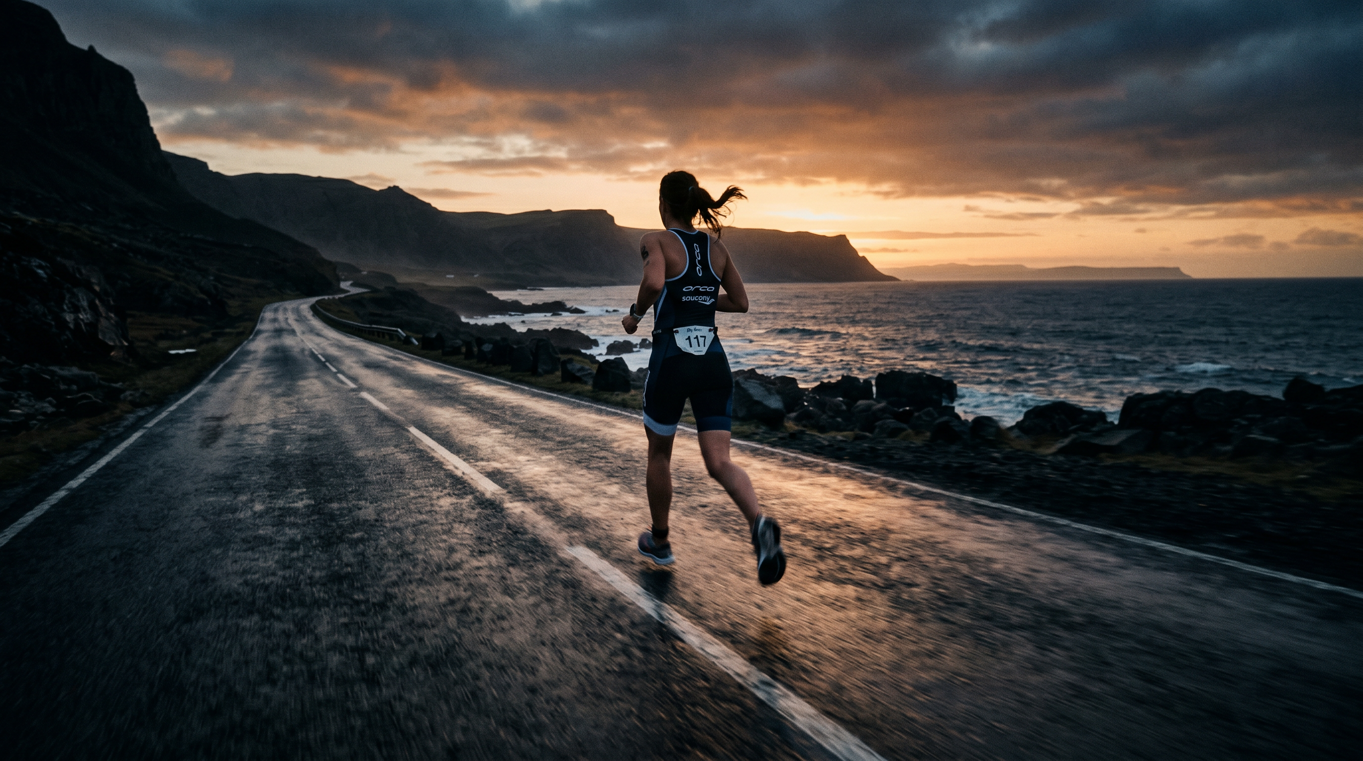 Triathlete running at dawn on a coastal road